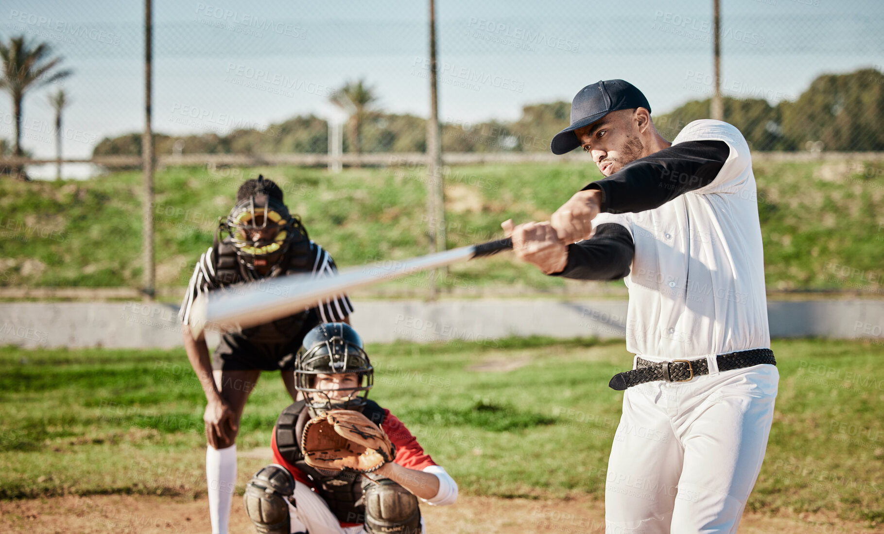 Buy stock photo Baseball, bat and swinging with a sports man outdoor, playing a competitive game during summer. Fitness, health and exercise with a male athlete or player training on a field for sport or recreation