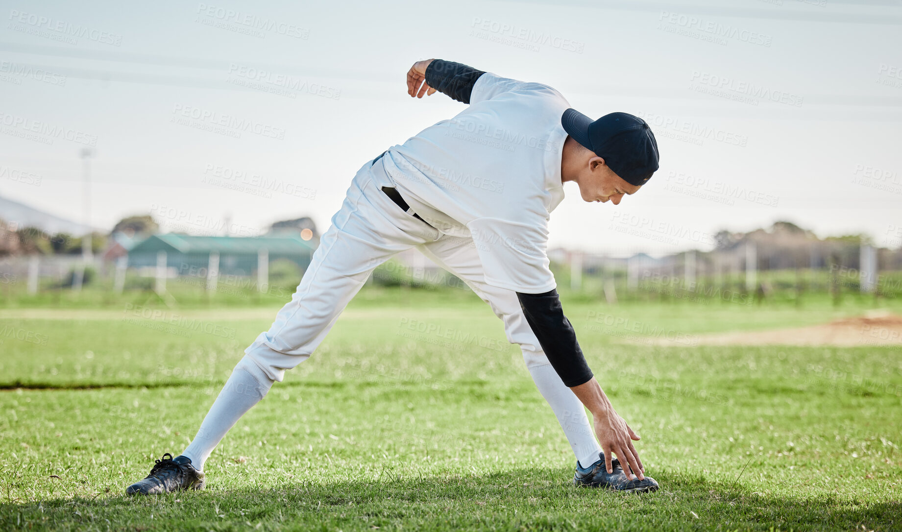 Buy stock photo Baseball stadium, stretching legs or man on field ready for training match on grass in summer. Healthy athlete, fitness workout or young sports player warm up to start softball exercise outdoors 