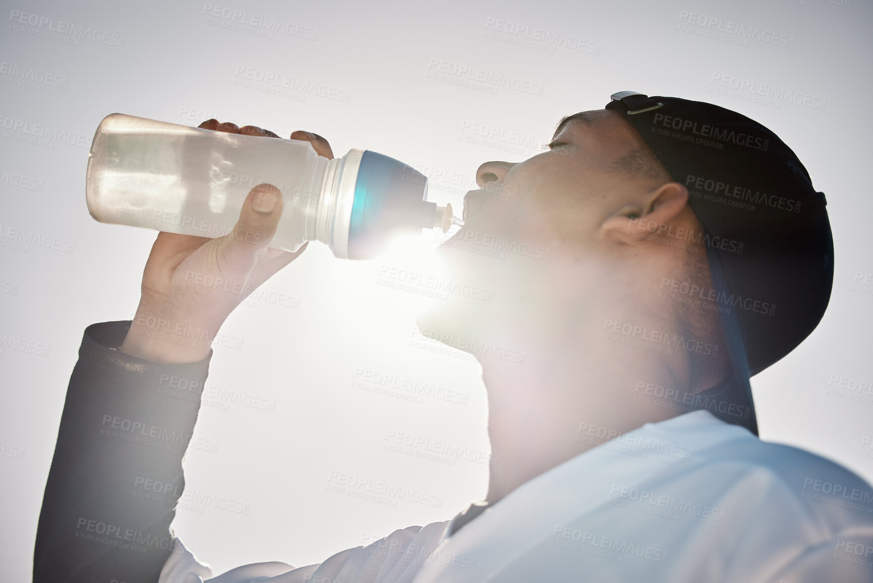 Buy stock photo Baseball player, drinking water or thirsty sports man on field in training match or game in a stadium. Sunshine, cardio fitness workout or healthy softball athlete drinks liquid for energy in summer 