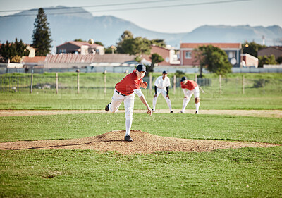 Baseball player, competitive and athlete throw or pitch ball in a match, game or training with a softball team. Sports, fitness and professional man pitcher in a competition with teamwork