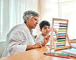 Education, autism and abacus with a grandmother teaching maths to her grandchild in the home for child development. Family, homework or study and a boy learning with a senior woman tutor in a house
