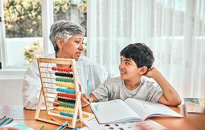 Buy stock photo Grandma help, child abacus learning and home studying in a family house with education and knowledge. Senior woman, boy and teaching of a elderly person with a kid doing writing for a class project
