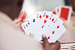 Game, holding and man playing cards, poker or black jack at a casino. Back, games and a guy showing a card in hands while gambling, having fun and learning a magic trick for s hobby or activity