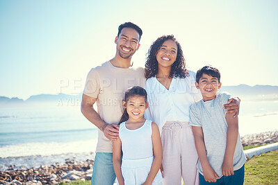 Buy stock photo Relax, smile and portrait of family at beach for vacation, bonding and summer break. Holiday trip, travel and care with parents and children on field by sea for positive, affectionate or quality time