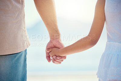 Buy stock photo Holding hands, family or children with a father and daughter outdoor together at the beach during summer. Kids, love or trust with a man and female child standing outside for bonding during the day