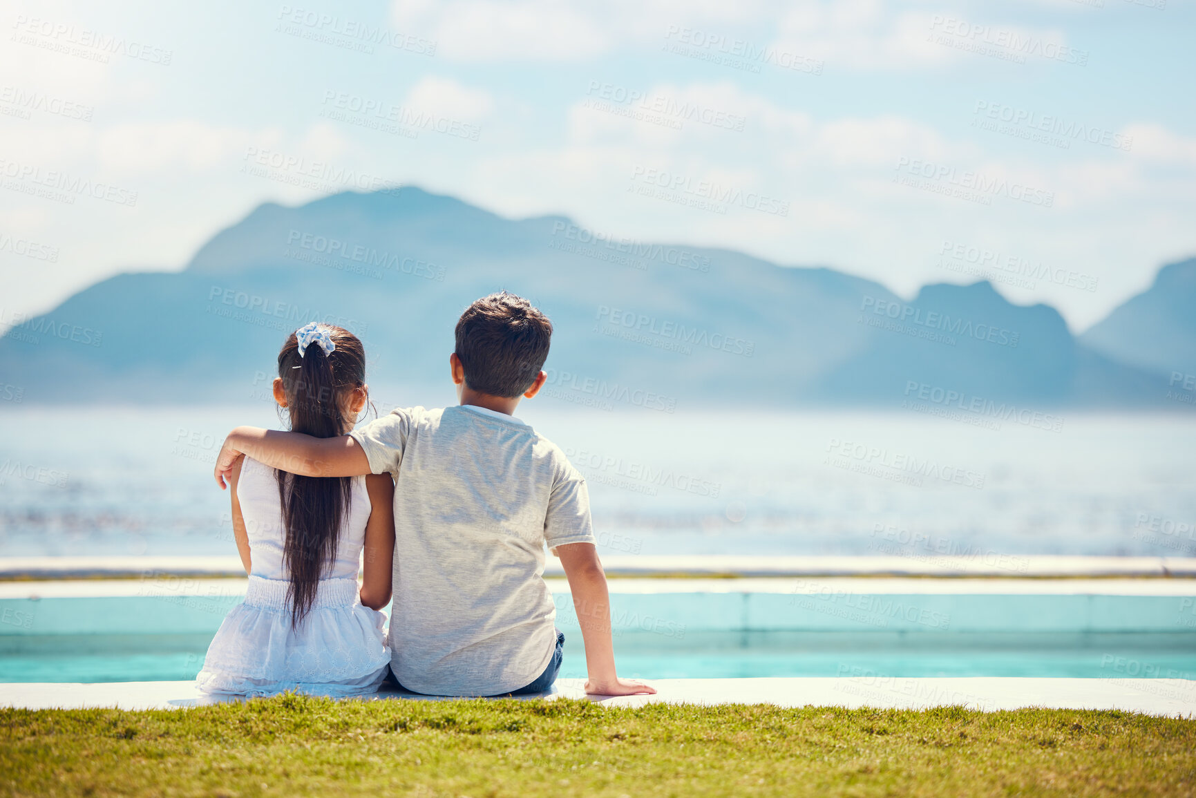 Buy stock photo Siblings, hug and back by ocean with love in mock up space for kids, family holiday and outdoor. Children, girl and boy with support by mountain, sea and waves with mockup on summer vacation on lawn