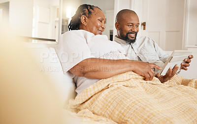 Buy stock photo Memory, photo album and love with a black couple sitting on a sofa in the living room of their home together. Nostalgia, retirement or relax with a senior man and woman looking at photographs