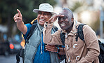 Travel, city tourism and men pointing on walk, explore vacation or tourist adventure in retirement. Happy friends, sightseeing search and smile on outdoor journey, direction or fun holiday experience