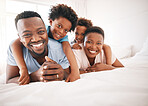 Happy, bonding and portrait of a black family on a bed for playing, quality time and comfort. Smile, love and African children with parents in the bedroom for happiness, relaxation and stress relief
