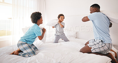 Buy stock photo Black family, pillow fight and father with children on bed for bonding, quality time and relax together. Love, happy and African dad laughing, playing and enjoy morning with kids in bedroom at home