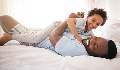 Buy stock photo Children, love and bedroom with a playful black family having fun in the morning together after waking up. Kids, smile or laughing with a father and happy son playing or joking on a bed in their home