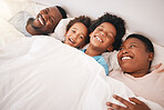 Funny, happy and relax with black family in bedroom for bonding, wake up and morning routine from top view. Smile, laugh and cute with parents and children at home for calm, weekend and quality time 
