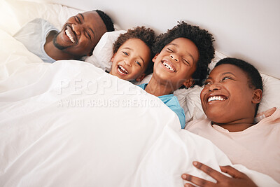 Buy stock photo Funny, happy and relax with black family in bedroom for bonding, wake up and morning routine from top view. Smile, laugh and cute with parents and children at home for calm, weekend and quality time 