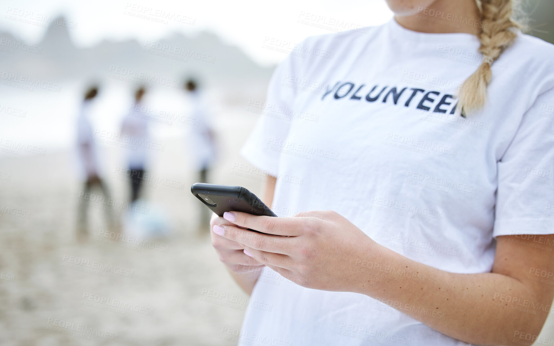 Buy stock photo Phone, hands and volunteer woman at beach for cleaning, social media and web browsing. Earth day, environmental sustainability and female with 5g mobile smartphone at seashore for community service.