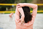 Back, stretching arm and woman at beach for volleyball practice, training or workout. Exercise, sports fitness and female athlete warm up, prepare or get ready to start match, game or competition.