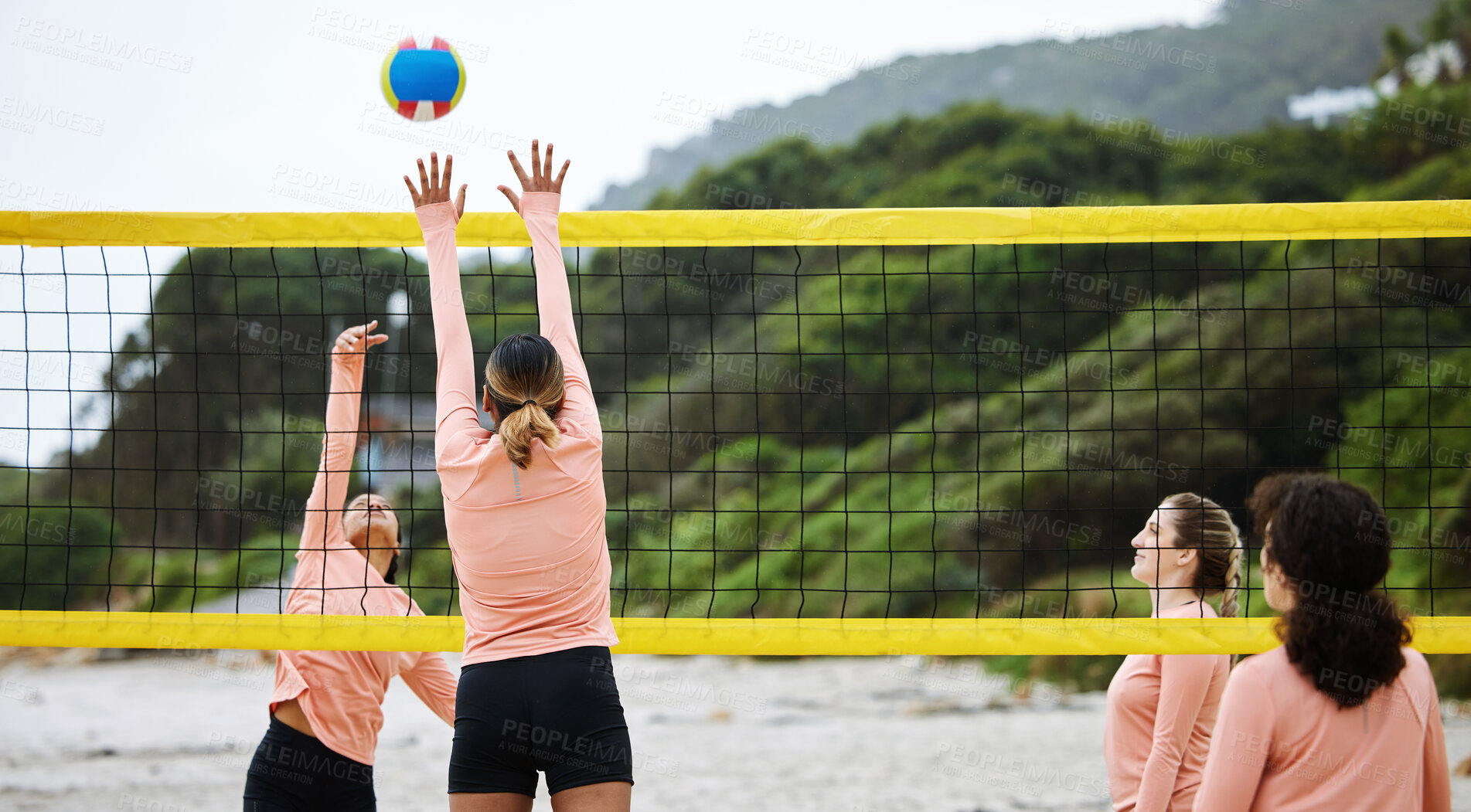 Buy stock photo Volleyball, beach and sand with sports women playing a game outdoor for training or competition. Team, sport and ball with female friends by the coast to play a competitive match during summer