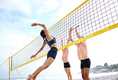 Beach volleyball, woman jump and sport in summer sunshine with friends, team and fitness in low angle. Sports, young women and hands in air, stretching and jumping for exercise, workout and ocean