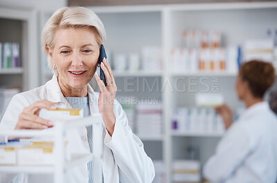 Buy stock photo Pharmacy medicine, pharmacist phone call and woman talking in drugstore for telehealth. Healthcare, smartphone and happy senior medical doctor in consultation for medication prescription in shop.