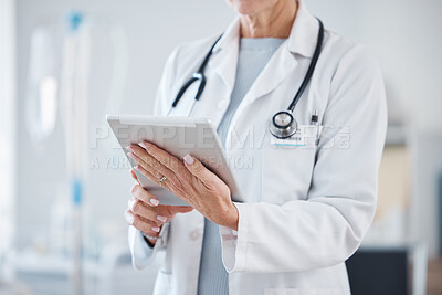 Buy stock photo Healthcare, tablet and hands of senior doctor in hospital for online consulting, telehealth and wellness app. Clinic, medicine and woman on digital tech for internet, medical research or patient data