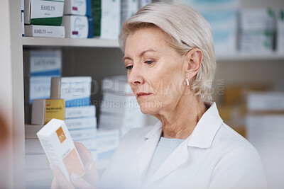 Buy stock photo Elderly pharmacist, medicine reading and stock in a healthcare, wellness and pharmaceutical store. Pharmacy inventory, working senior woman and medical product check of a employee at a drugstore