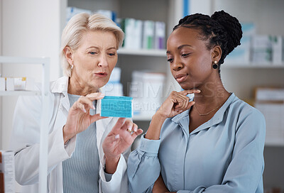Buy stock photo Healthcare, help and black woman with medicine from a pharmacist, dosage information and recommendation. Medical, sick and doctor reading label on a box of pills with an African patient for medicare