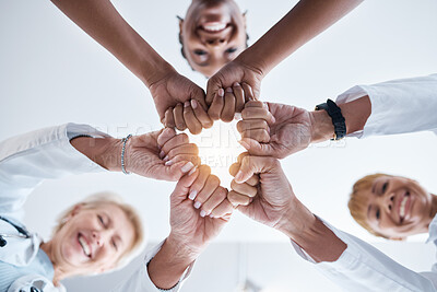 Buy stock photo Doctor, group and fist hands in circle for teamwork portrait, happiness or support in hospital for healthcare goal. Doctors, clinic team and huddle for motivation, solidarity and diversity with women