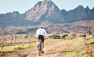 Buy stock photo Back of man, mountains and cycling in nature, countryside and training for triathlon, sports and race in Cape Town. Cyclist, mountain bike and outdoor bicycle for marathon fitness, exercise or cardio