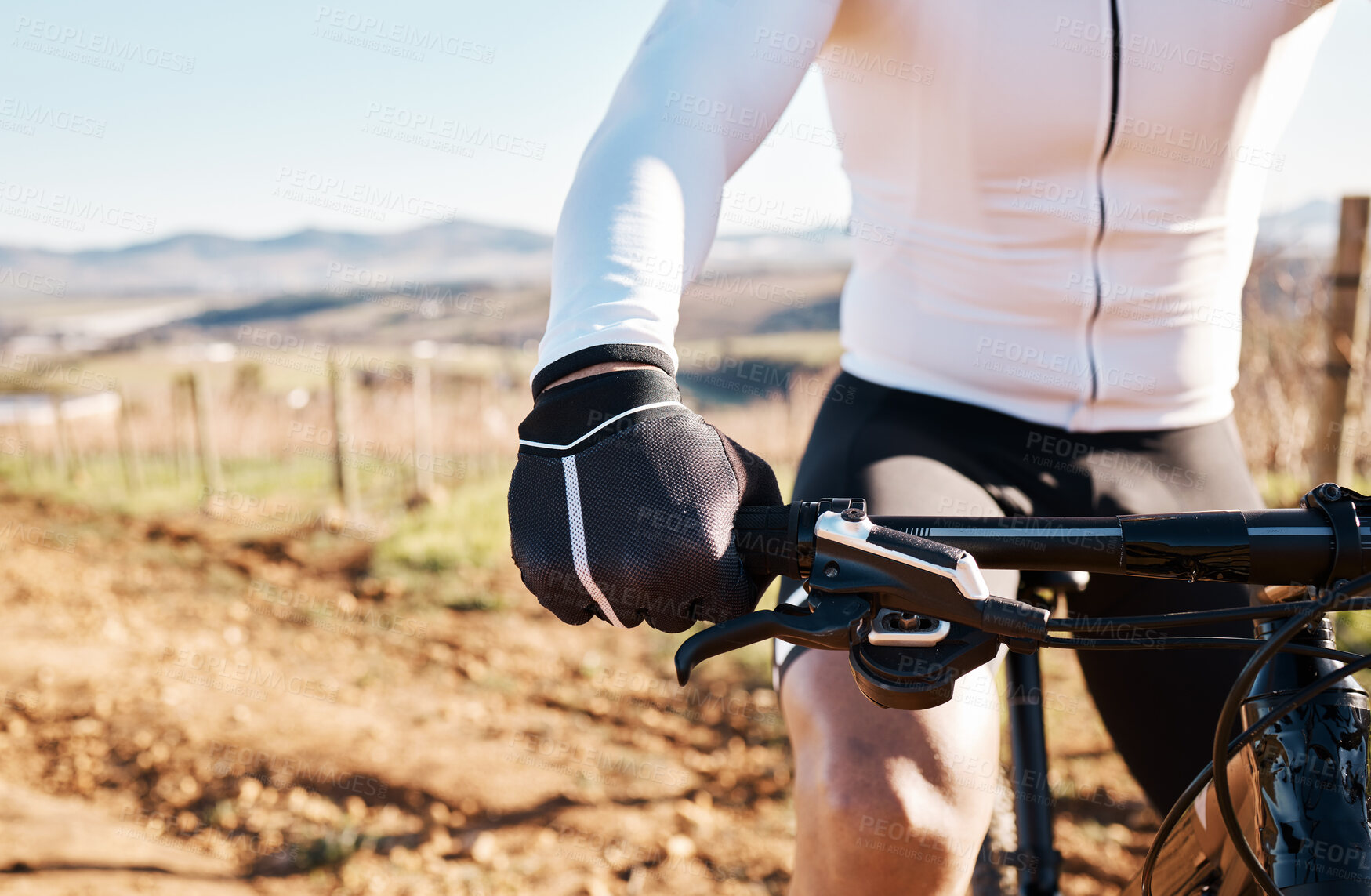 Buy stock photo Man, hands and bicycle in countryside, nature and training in sunshine for triathlon, sports and cardio competition. Cyclist gloves, bike and outdoor fitness for cycling marathon, exercise and race