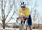 Cycling, fitness and man with bike in park, smile and take break from cyclist outdoor with helmet for safety. Sunglasses, happy male and athlete, training for race and exercise in nature with bicycle