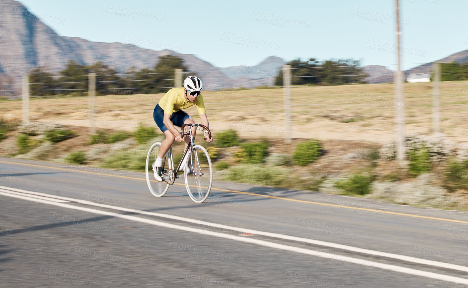 Buy stock photo Cycling, fitness and man with bicycle on road, challenge and action with workout, cyclist outdoor and helmet for safety. Riding, athlete and training for race or triathlon, exercise with bike