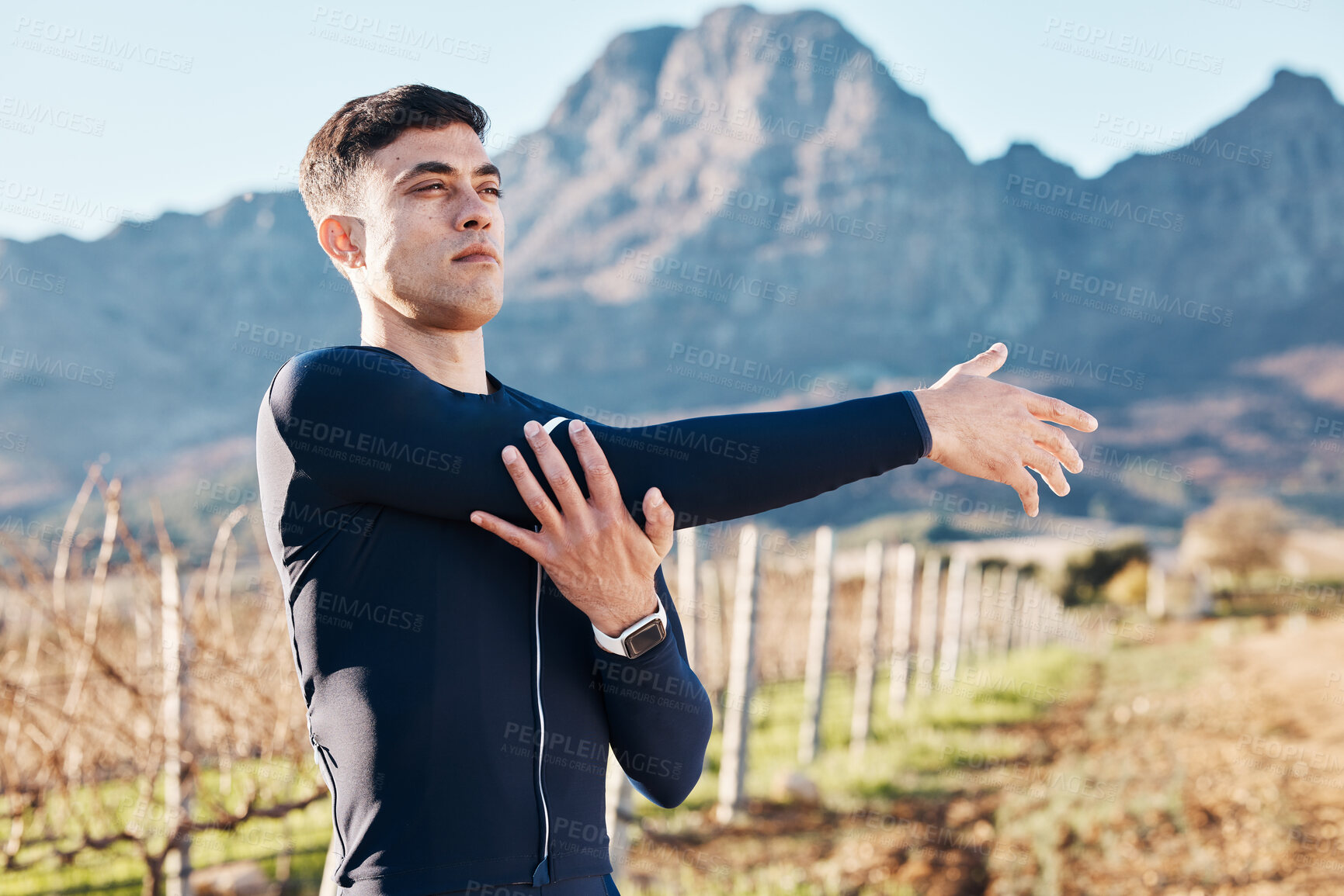 Buy stock photo Man, stretching arms with run and fitness outdoor, nature view with hiking or running in countryside, exercise and warm up. Serious, muscle and strong male runner, start with marathon or trekking