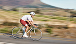 Cycling, exercise and man with bike on road, speed and action with motion blur of cyclist outdoor and helmet for safety. Mockup space, athlete and training for race, fitness in nature with bicycle