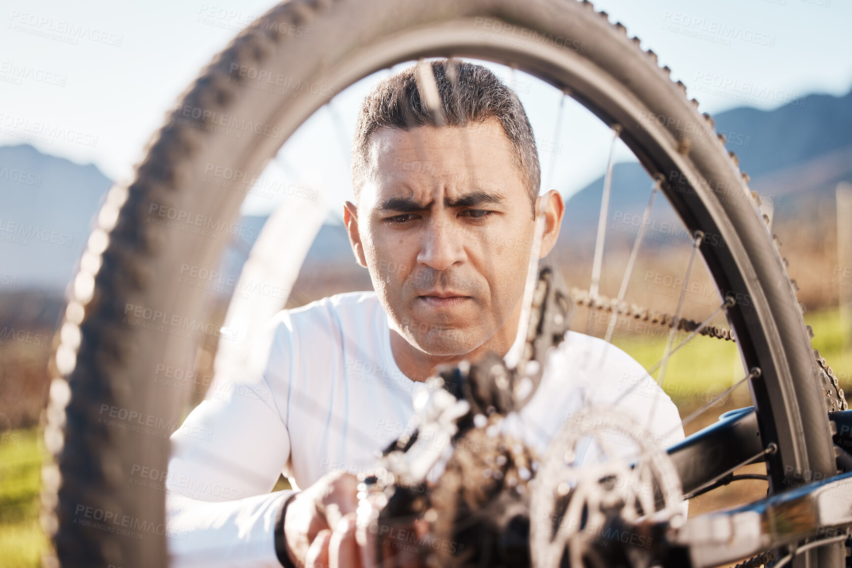 Buy stock photo Cycling, repair and wheel with man in nature for sports, wellness and fitness training. Adventure, safety and tire change with cyclist fixing mountain bike on trail for broken, puncture and check