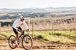 Man, bike and cycling with motion blur in nature, countryside and training of triathlon, sports or power. Cyclist, bicycle and speed of off road travel, energy and freedom in action, wellness or path