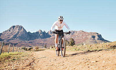 Buy stock photo Man, mountains and cycling on trail in nature, countryside and blue sky for triathlon sports in Cape Town. Cyclist, bicycle and off road path outdoor for fitness, bike exercise and energy in sunshine