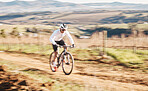 Man, bicycle and cycling with motion blur in nature, countryside and training for triathlon, sports and power. Cyclist, mountain bike and speed for off road travel, exercise or professional challenge