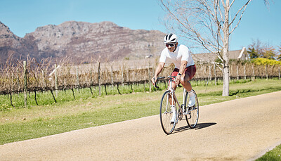 Buy stock photo Man, athlete and bicycle in nature, sunshine and training for triathlon sports in Cape Town. Cyclist, mountain bike and cycling in field, off road path and outdoor fitness for performance in summer