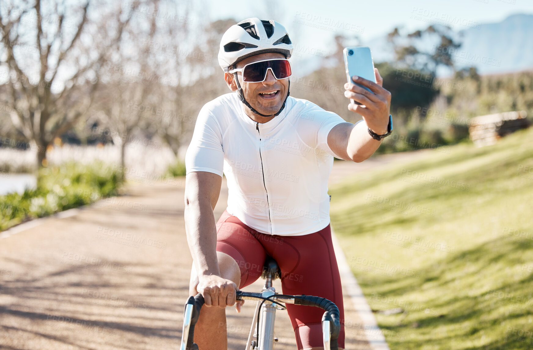 Buy stock photo Man on bike, selfie and smile, fitness and cycling in park, happy and helmet for safety, train for race outdoor. Cycling, bicycle and male athlete, exercise and smile in picture for social media post