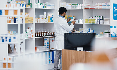 Buy stock photo Black man pharmacist, pharmacy stock check and employee in a wellness, healthcare and drugs clinic. Reading, medical information and a retail pharmaceutical worker with pills storage and supplements