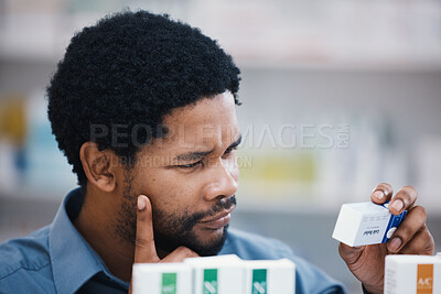 Buy stock photo Black man, medical product and thinking in pharmacy for reading, choice and pills in retail healthcare. African customer, box and sale for health, deal and wellness for benefits of medicine in store