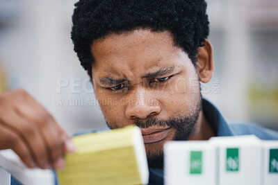 Buy stock photo Black man, shopping or reading in pharmacy for medicine, choice or pills in retail healthcare for wellness. African customer, box or sale for health, deal or thinking for benefits of medical product