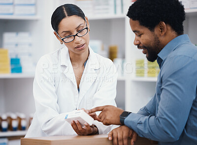 Buy stock photo Pharmacist, woman or helping patient with medicine information, pills instruction or medical consulting in store. Pharmacy worker, black man or customer with healthcare questions on drugs product box