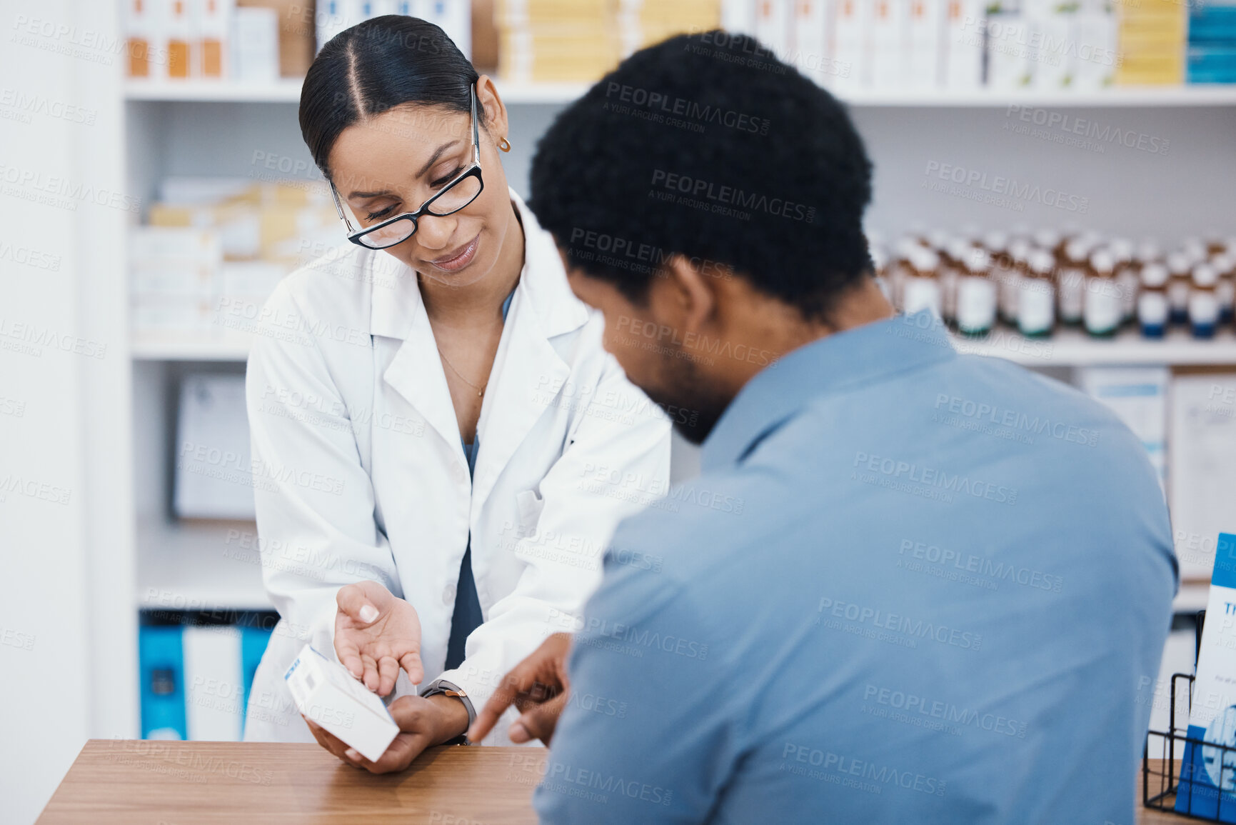 Buy stock photo Pharmacist, woman or helping customer with medicine information, pills instruction or medical consulting in store. Pharmacy worker, black man or patient with drugs questions on healthcare product box