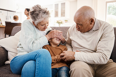 Buy stock photo Happy, playful and child with grandparents on sofa of family living room for bonding, affectionate and fun. Playing boy, hide and seek with senior people at home for happiness, generations and games