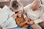 Love, grandparents and boy on couch, playing and quality time for happiness, carefree and bonding. Granny, grandfather or grandchild on sofa, loving together or relax on break, happy or kid in lounge