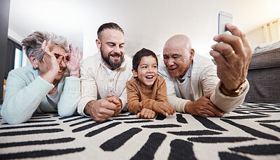 Buy stock photo Happy big family, smile and take selfie in home living room for memory or social media. Photographer care, comic face and father, grandparents and child on floor taking pictures, bonding or laughing.