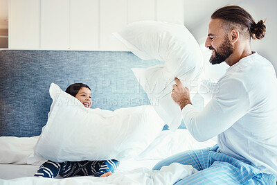 Buy stock photo Happy, love and father in pillow fight with his child on the bed in the bedroom of family house. Happiness, smile and dad being playful with his boy kid while bonding, playing and having fun at home.