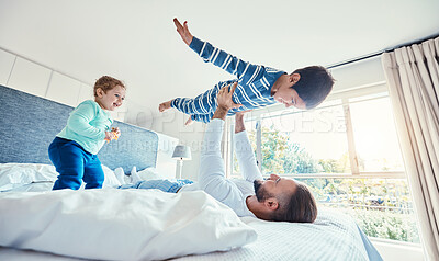 Buy stock photo Love, father and boy on bed, airplane and quality time with happiness, break and vacation. Dad, children and kids in bedroom, son in air and smile for playing, games and relax on weekend and bonding