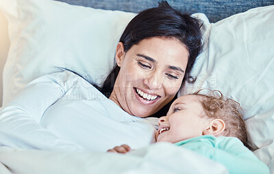Buy stock photo Love, baby and mother relax in bed, waking up and bonding, happy and smile together in their home. Rest, family and mom with child in a bedroom, laughing and sharing special moment of motherhood