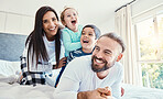 Portrait, family and laughing on bed in home, having fun and bonding together. Comic, love and care of happy father, mother and kids or boys playing, smile and enjoying quality time in house bedroom.